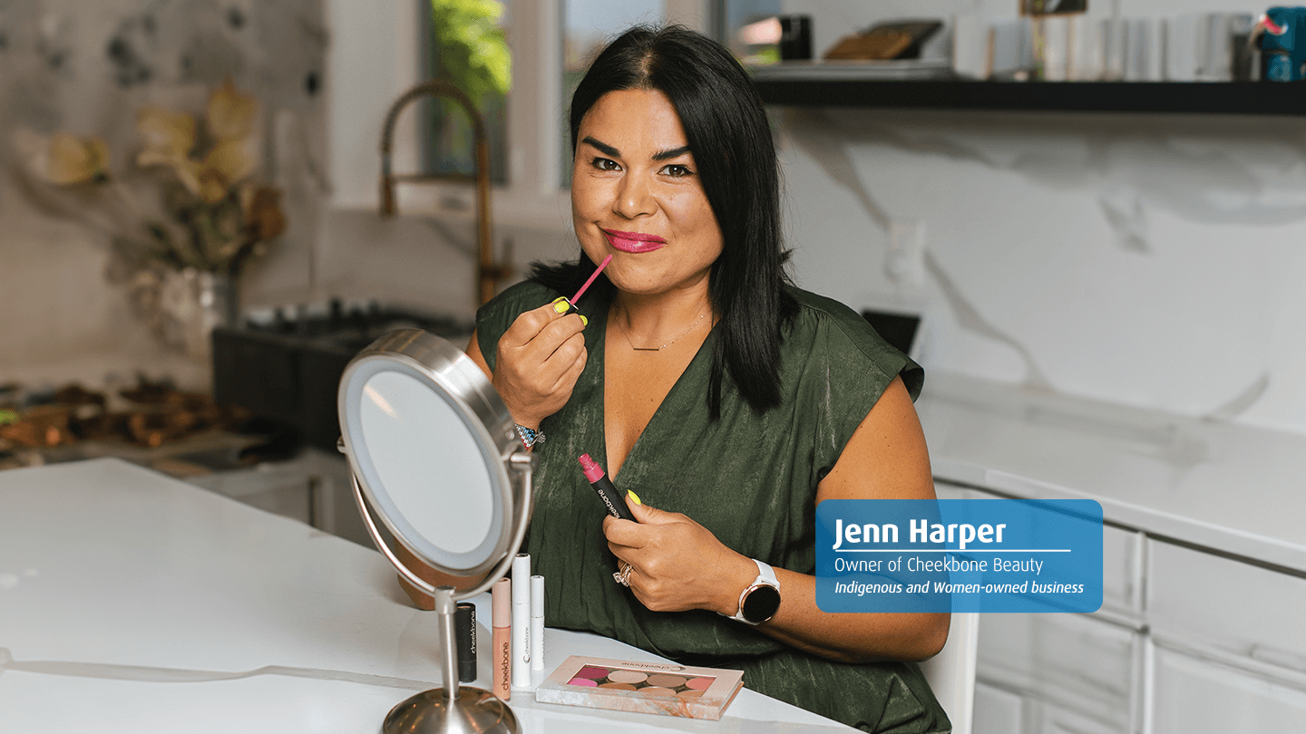 Jenn Harper, owner of Cheekbone Beauty, applying lip gloss.